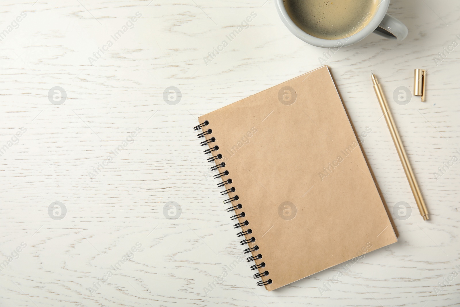 Photo of Notebook and cup of coffee on wooden background, top view with space for text