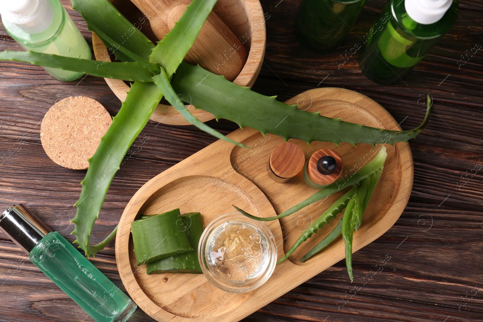 Photo of Flat lay composition with homemade aloe gel and fresh ingredients on wooden table