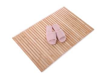 Photo of Bamboo rug with soft slippers isolated on white. Bath accessory