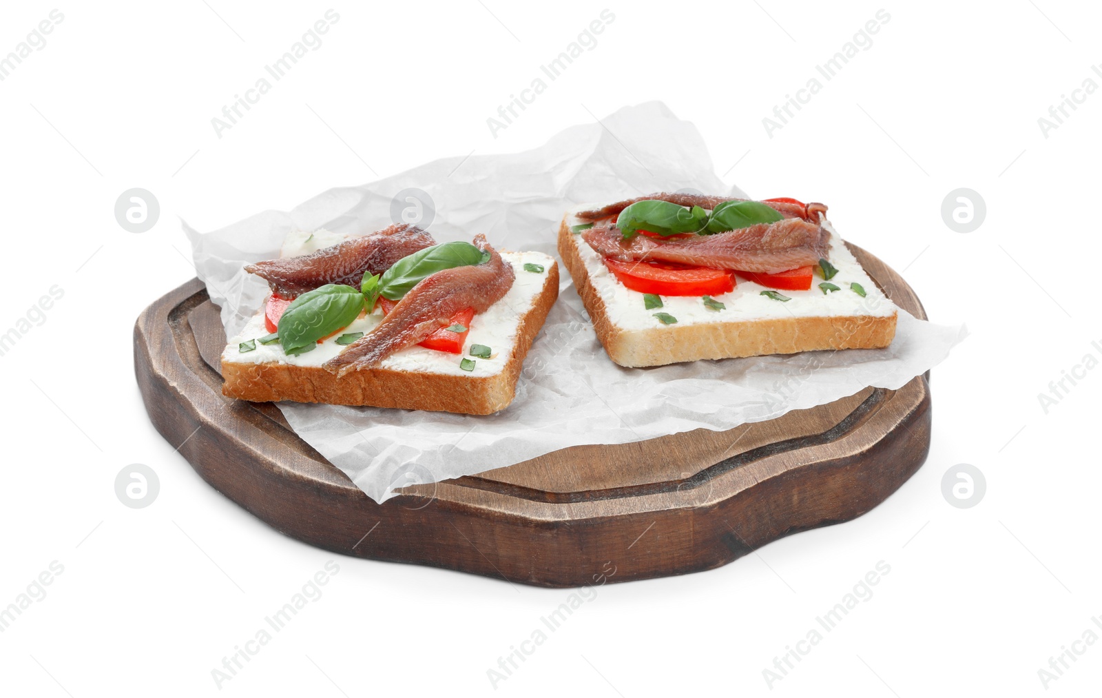 Photo of Delicious sandwiches with cream cheese, anchovies, tomatoes and basil on white background