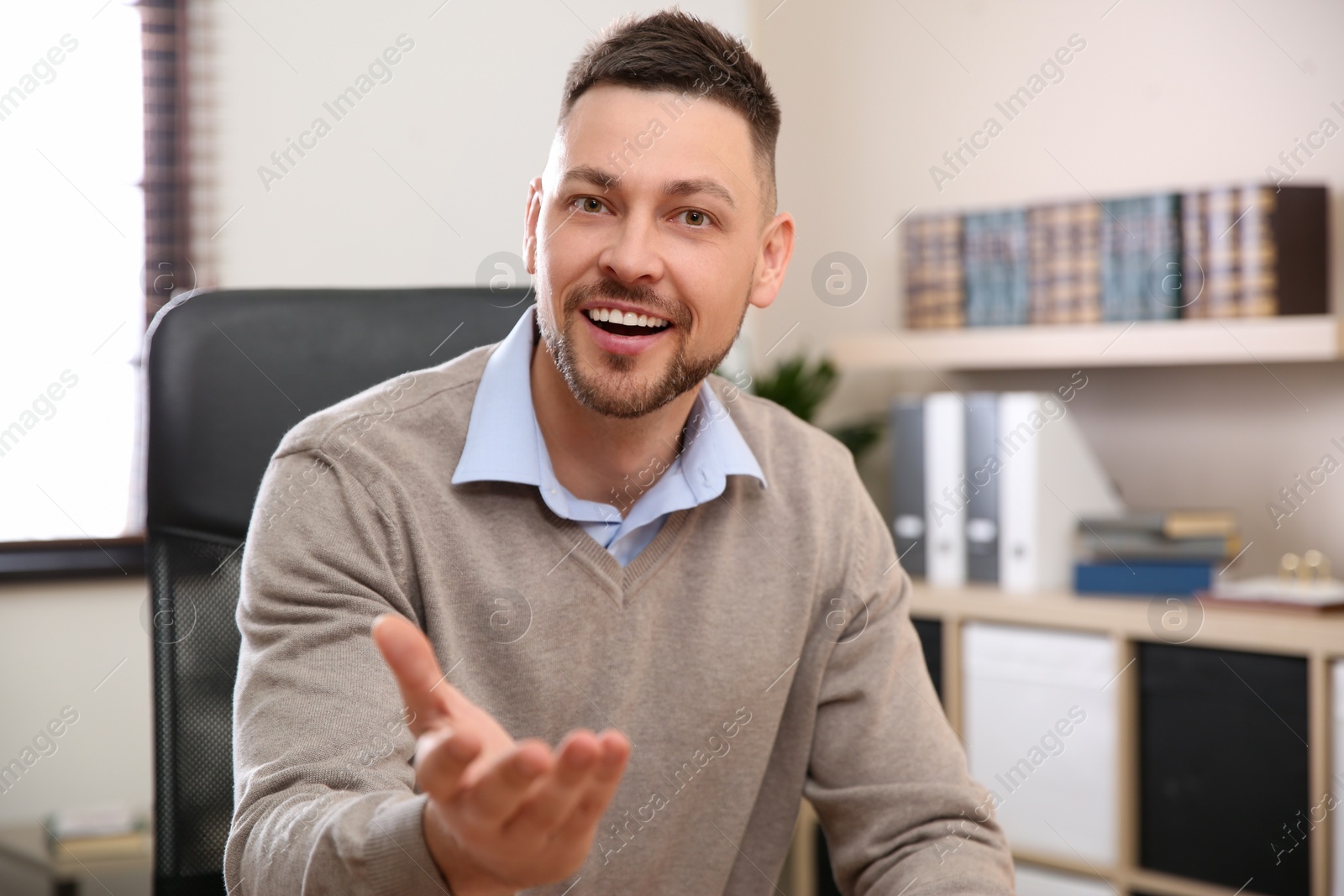 Photo of Man using video chat in office, view from web camera