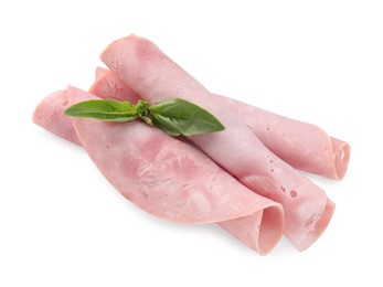 Rolled slices of tasty ham and basil isolated on white