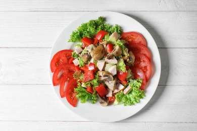 Photo of Plate with delicious fresh salad on table, top view