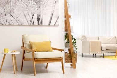 Photo of Spring atmosphere. Cosy armchair and coffee table in stylish room