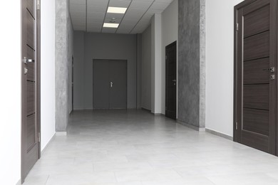 Photo of Empty office corridor with wooden doors, Interior design