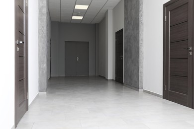 Empty office corridor with wooden doors, Interior design