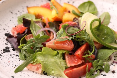 Photo of Delicious salad with vegetables and peach in bowl, closeup