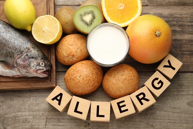 Image of Food allergy. Different fresh products and cubes on wooden table, flat lay