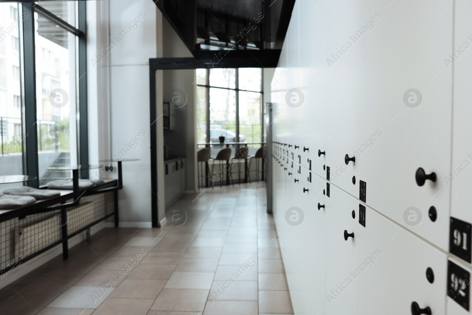 Photo of Hostel dining room interior with modern furniture and white lockers