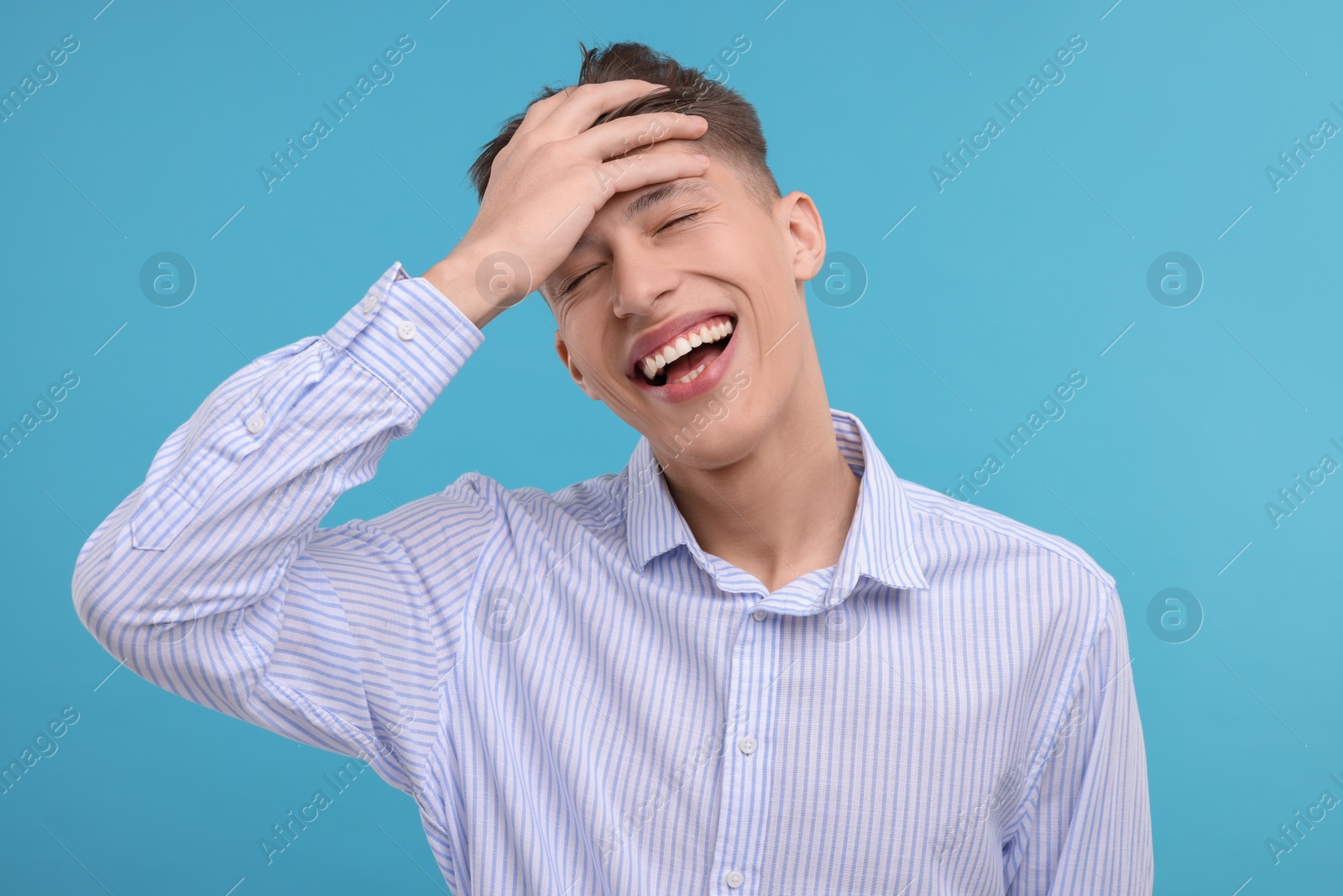 Photo of Young man laughing on light blue background