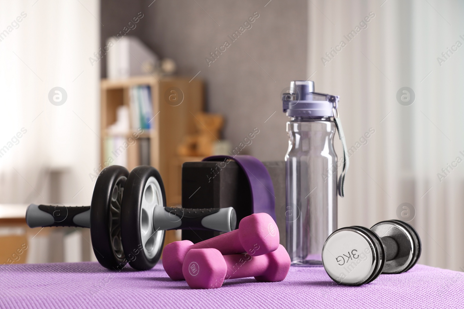 Photo of Many different sports equipment on mat indoors