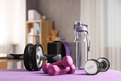 Photo of Many different sports equipment on mat indoors