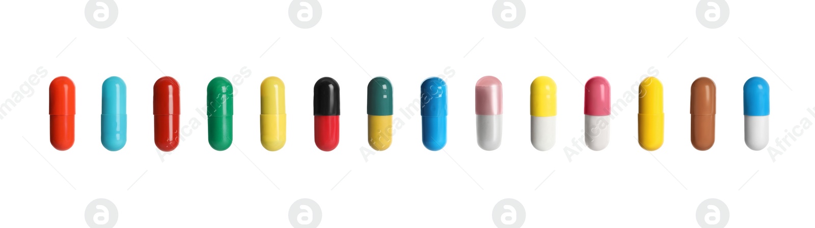 Image of Set of different color pills in row isolated on white