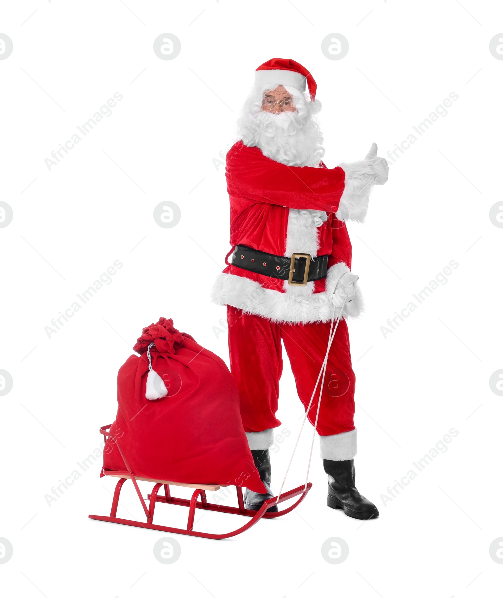 Photo of Man in Santa Claus costume with bag and sleigh on white background