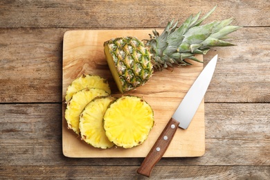 Photo of Flat lay composition with cut fresh juicy pineapple on wooden table