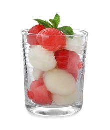 Glass with melon and watermelon balls on white background