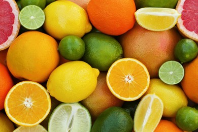 Different fresh citrus fruits as background, top view