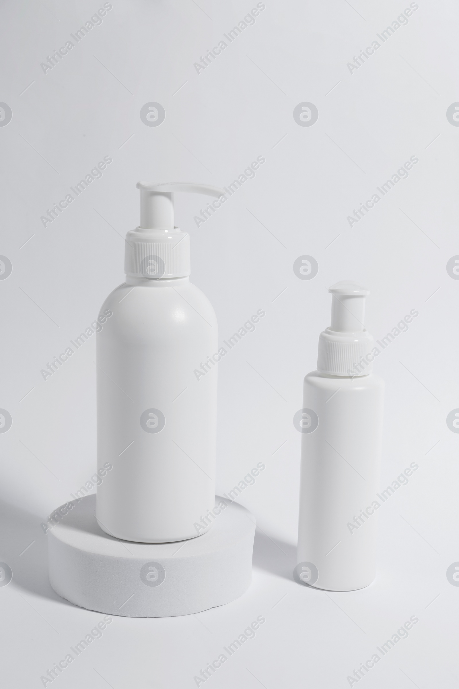 Photo of Bottles with cosmetic products on white background