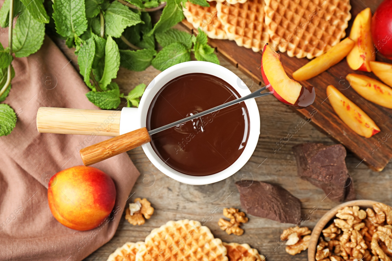 Photo of Flat lay composition with chocolate fondue on table