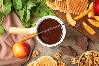 Photo of Flat lay composition with chocolate fondue on table