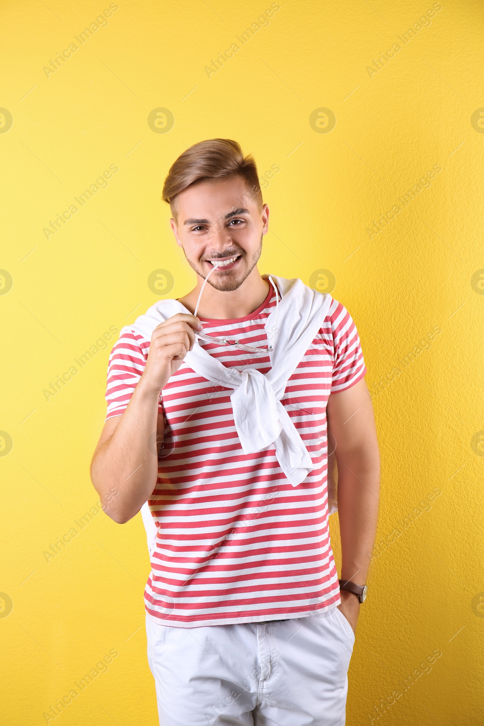 Photo of Young man with trendy hairstyle on color background