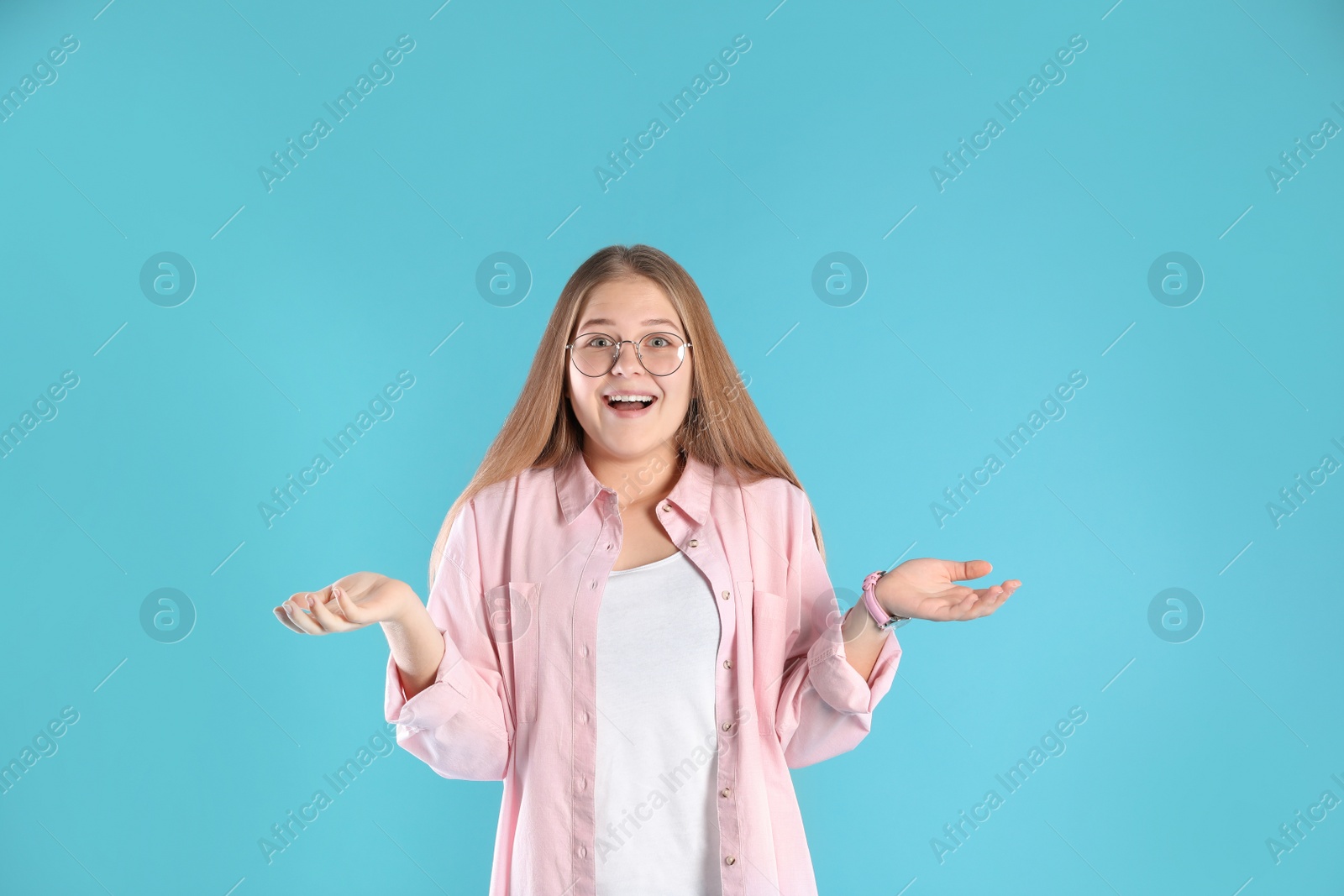 Photo of Portrait of emotional teenage girl on color background