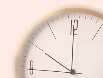 Closeup view of clock, motion blur effect. Time concept