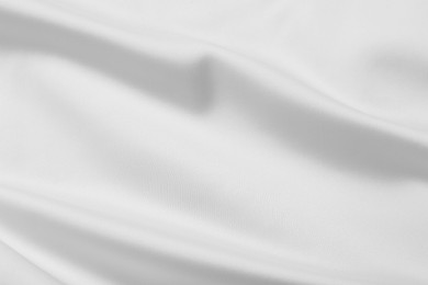 Photo of Texture of white silk ripple fabric as background, top view