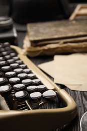 Photo of Typewriter on black wooden table, closeup. Detective's workplace