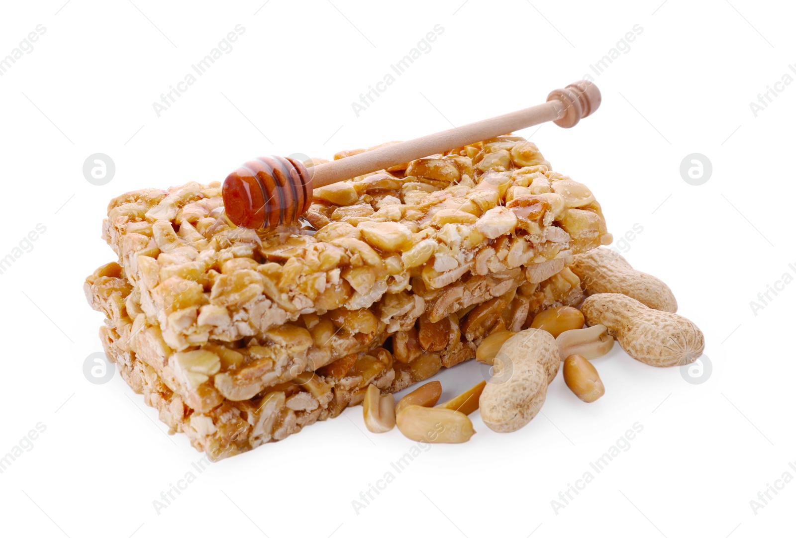 Photo of Tasty kozinaki bars, peanuts and dipper with honey isolated on white