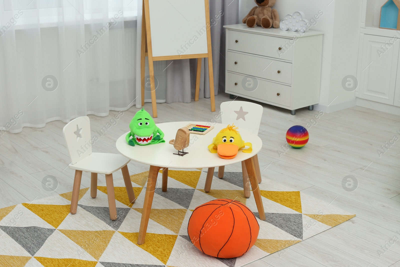 Photo of Child`s playroom with different toys and modern furniture. Stylish kindergarten interior