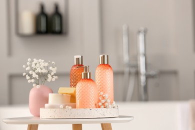 Photo of Liquid soap and other toiletries on white table in bathroom
