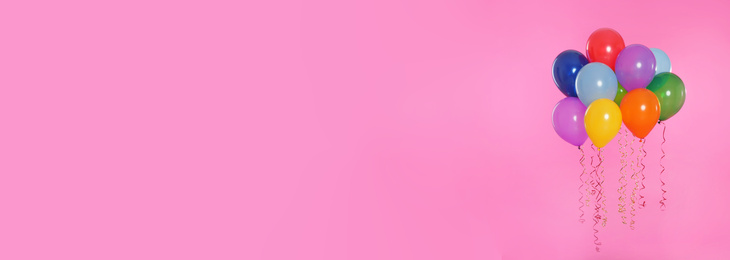 Bright balloons on pink background, space for text. Banner design 