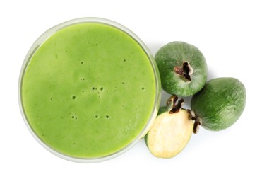 Fresh feijoa smoothie in glass and fresh fruits on white background, top view