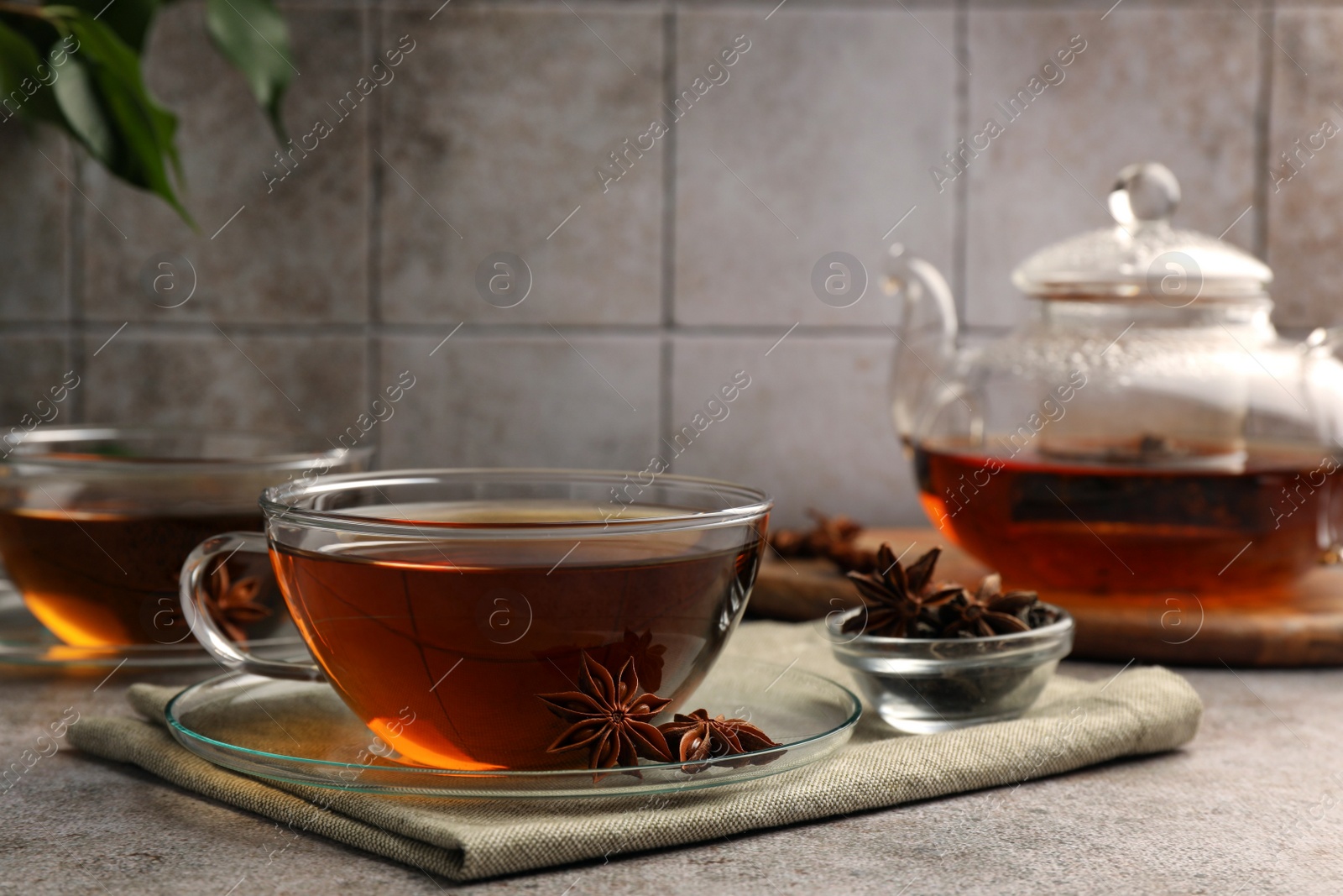 Photo of Aromatic tea with anise stars on light grey table