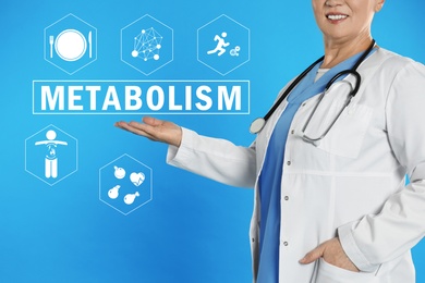 Image of Metabolism concept. Doctor with stethoscope on blue background, closeup