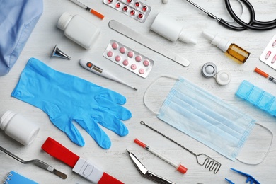 Flat lay composition with medical objects on white wooden background