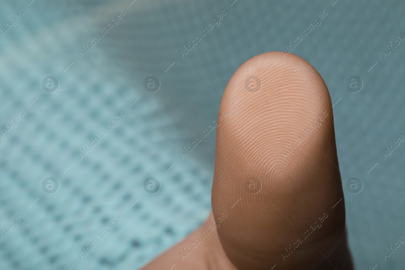 Photo of Woman pressing finger to surface, closeup view. Scanning fingerprint