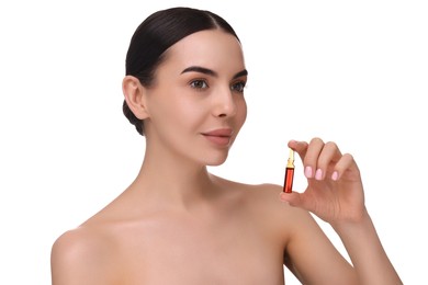 Beautiful young woman holding skincare ampoule on white background