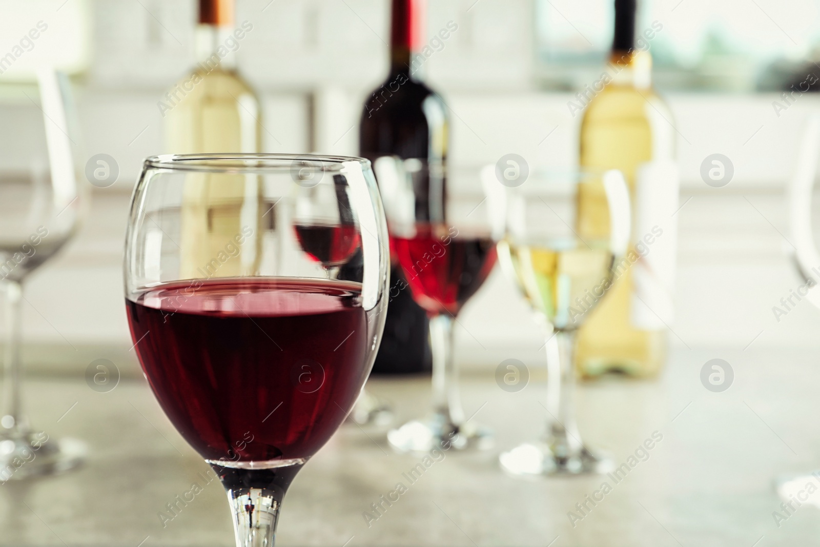 Photo of Glass of delicious red wine on table