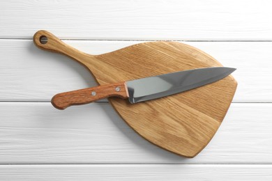 Photo of One sharp knife and board on white wooden table, top view