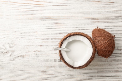 Photo of Nut with fresh coconut milk on wooden background