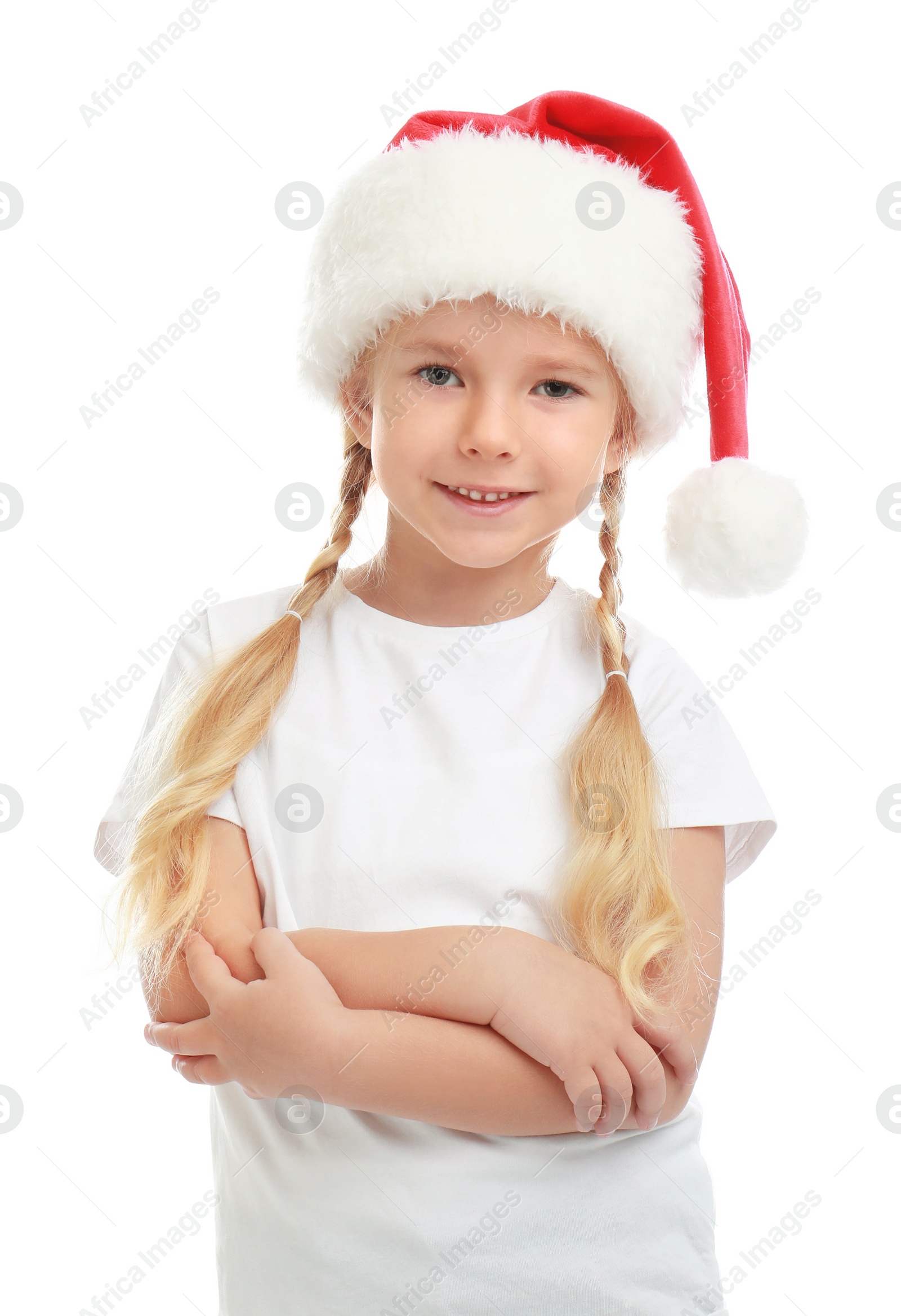 Photo of Cute little child wearing Santa hat on white background. Christmas holiday