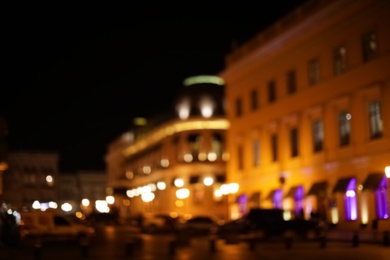 Photo of Blurred view of street with lights at night. Bokeh effect