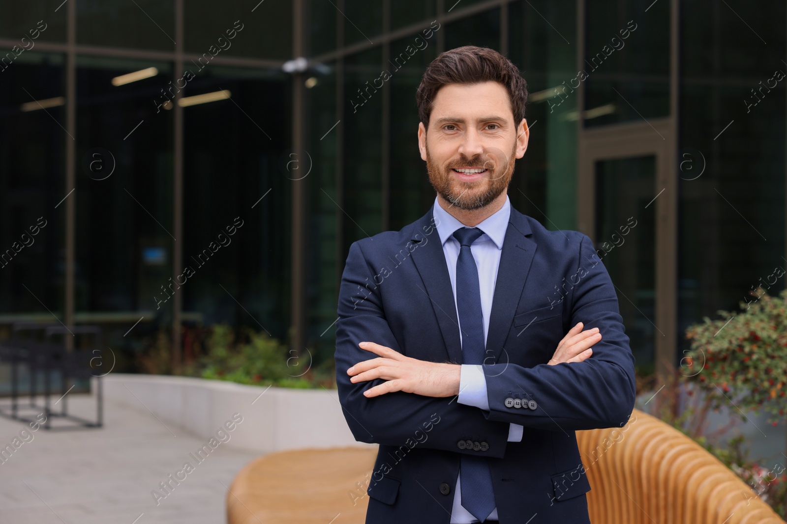 Photo of Male real estate agent outdoors. Space for text