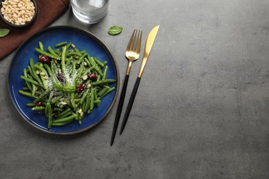 Photo of Tasty salad with green beans served on grey table, flat lay. Space for text