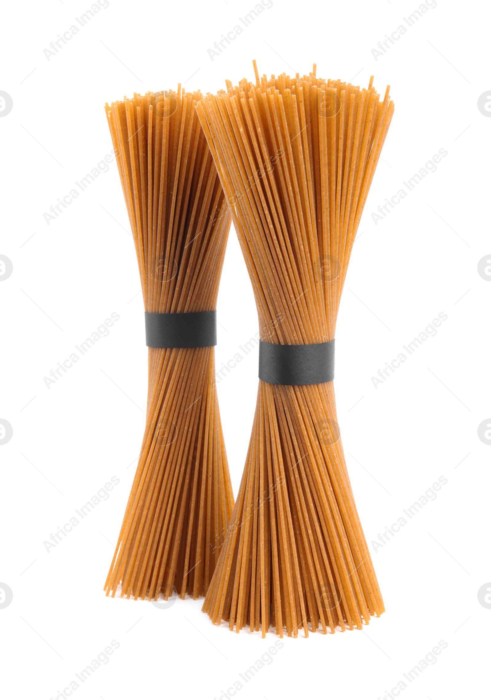 Photo of Uncooked buckwheat noodles isolated on white. Japanese cuisine