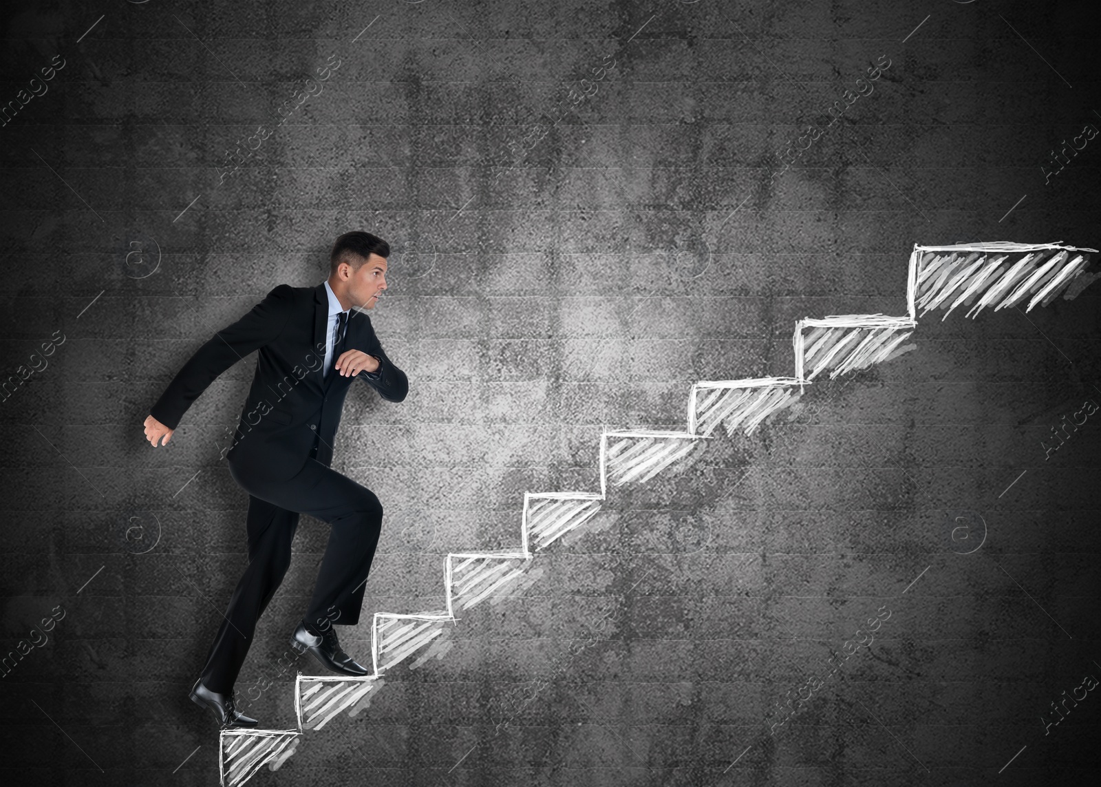 Image of Businessman walking up stairs drawing with chalk on dark background. Career ladder concept