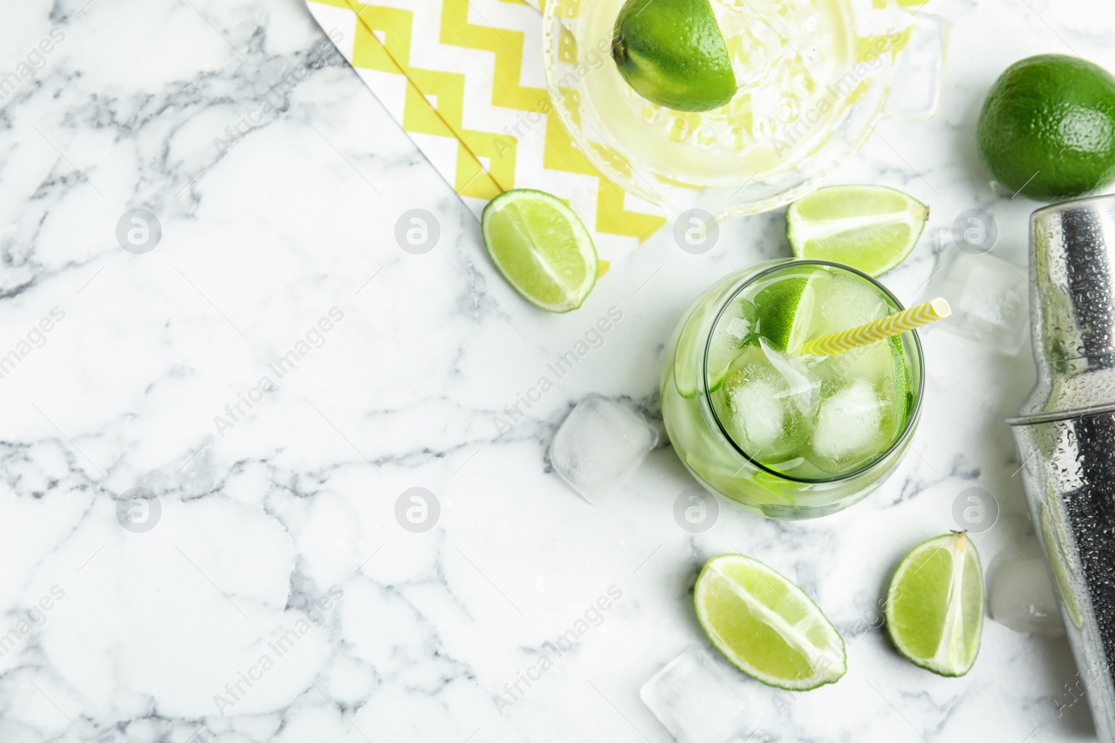 Photo of Delicious mojito and ingredients on white marble table, flat lay. Space for text