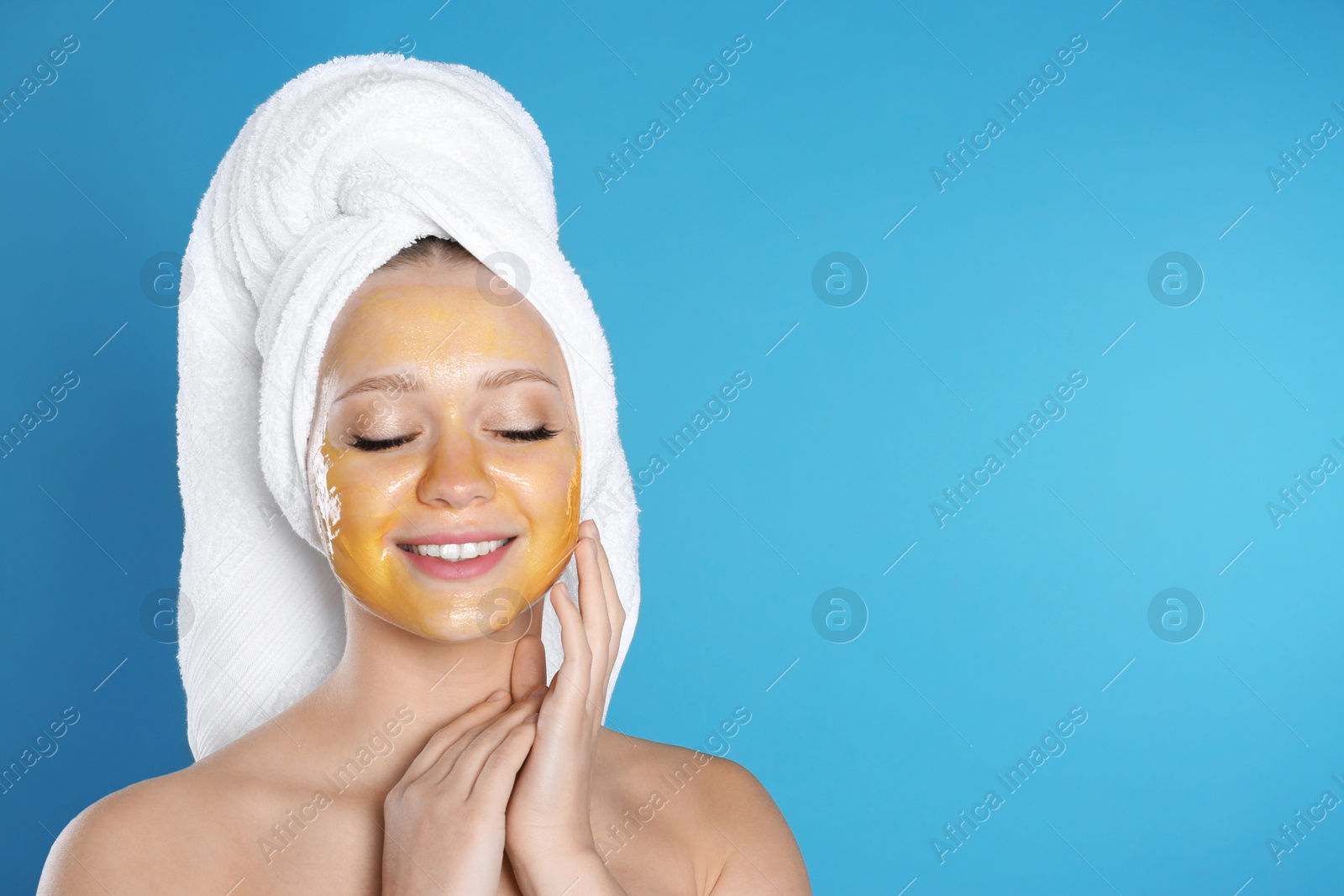 Photo of Beautiful woman with natural mask on her face against color background. Space for text